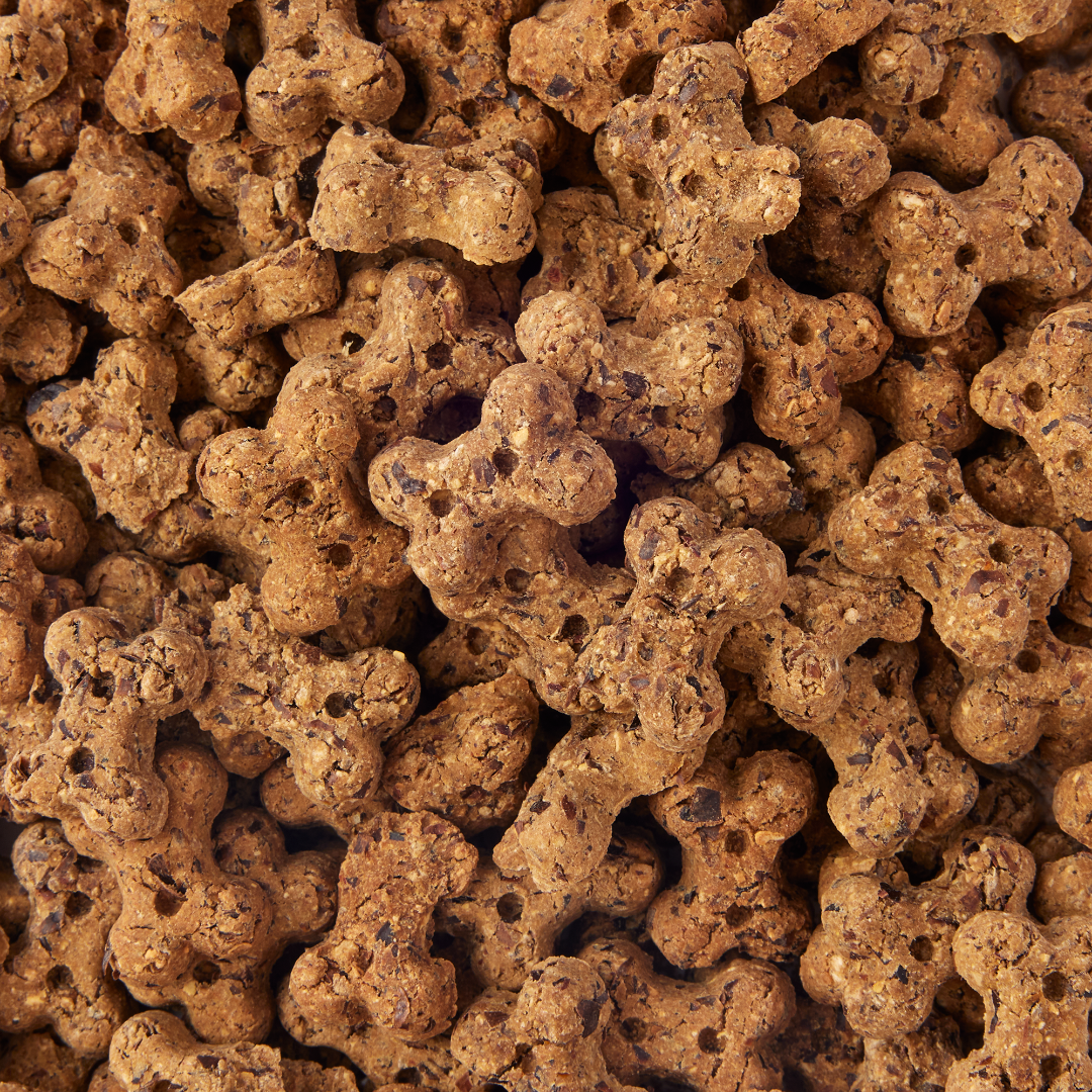 Close-up of brown dog treats shaped like bones.