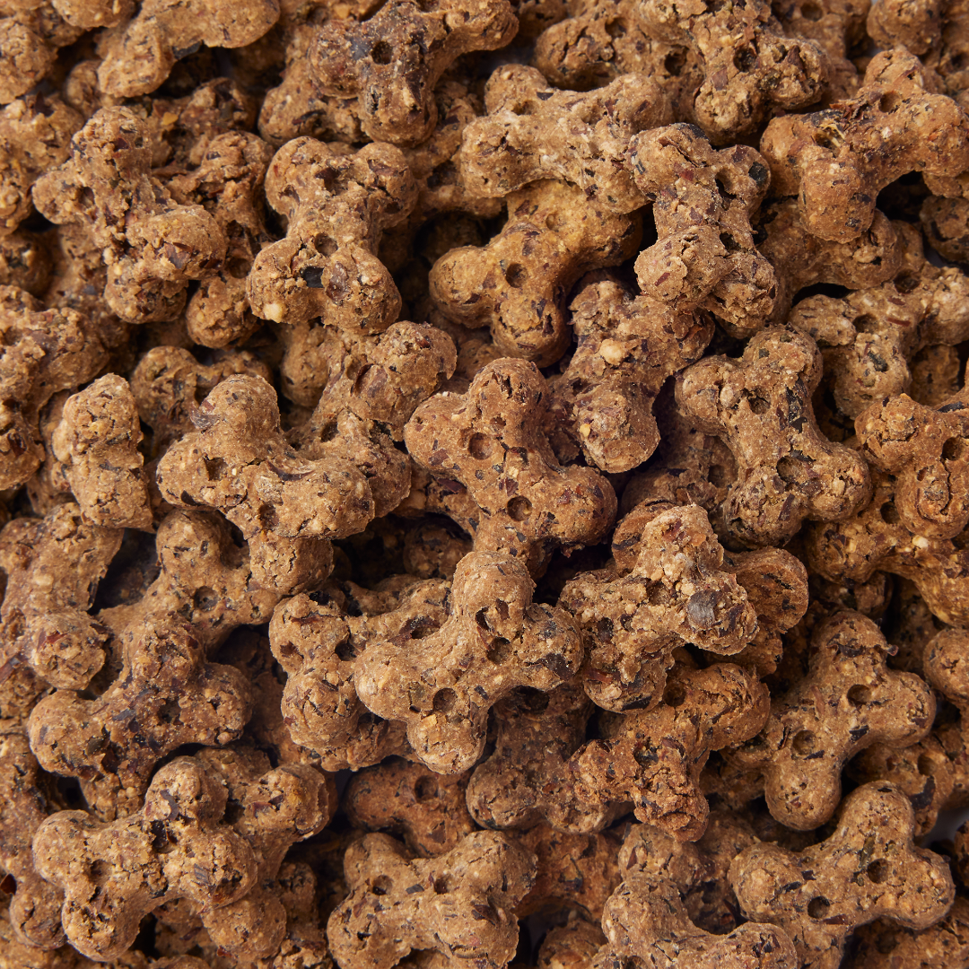 Close-up of brown dog treats shaped like bones.